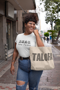 Woman holding canvas tote bag with word Talofa on it